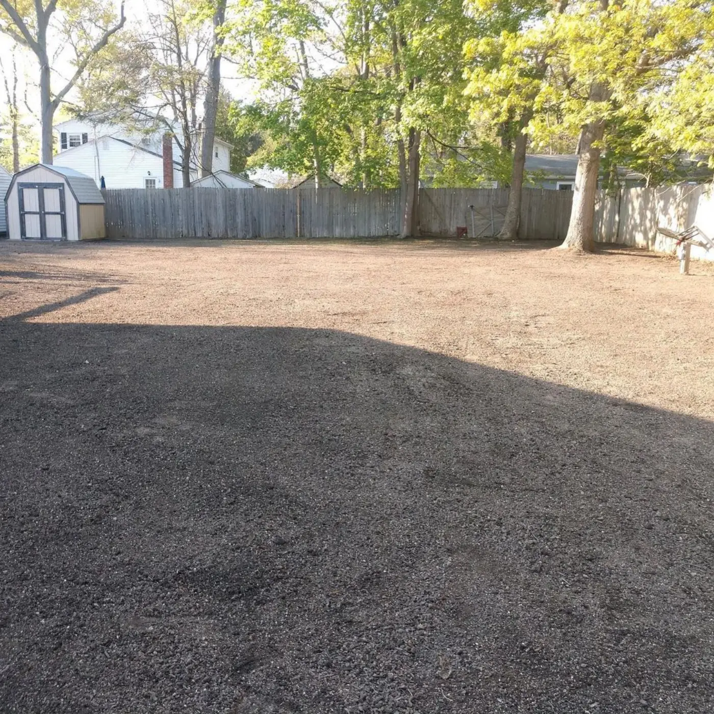 Backyard graded flat and raked, ready for seed